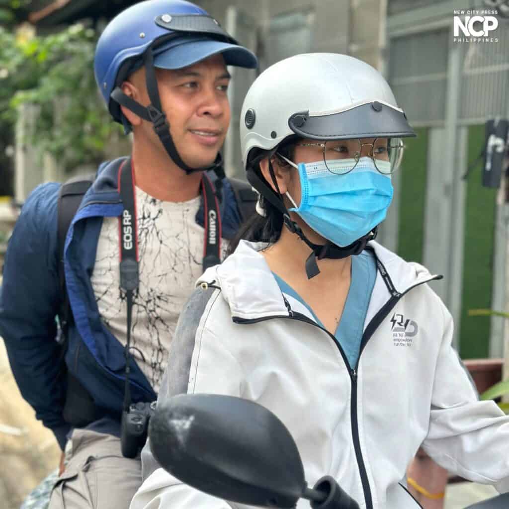 Leo on a motorcycle with a student volunteer