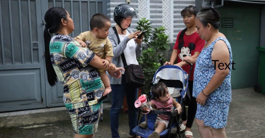 Ms. Doan (wearing a helmet) trying to convince a mother to let her child return to school