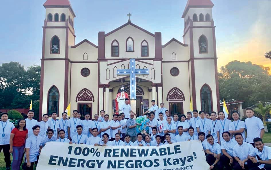 Bishop Alminaza ampaigning with seminarians for renewable energy for Negros Island in front of the San Carlos Borromeo Cathedral